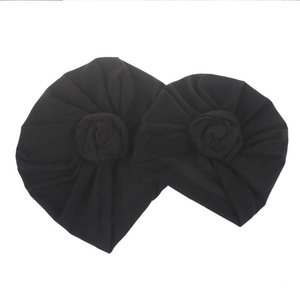 Two-piece black bohemian baby turban set with front rose knot detail on white background