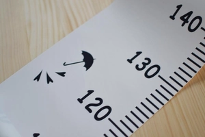 Detail of canvas height chart showing black scale markers 120-140cm and umbrella icon