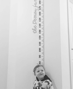 Detail of wooden growth chart for kids room with scale marks from 80cm to 180cm