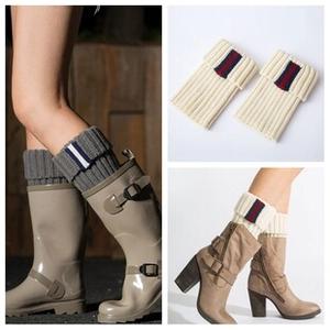 Detail of knitted leg warmers with contrast stripes and soft ribbed texture