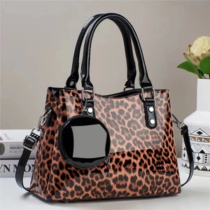 Glossy leopard print tote bag with black faux leather handles and round coin purse charm