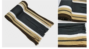 Macro detail of striped knit winter scarf with fringe tassels in black, beige and brown