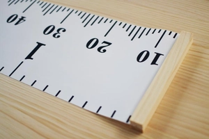 Macro shot of the natural wooden frame and measurement scale on kids height growth chart
