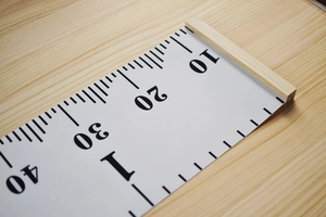 Close-up of printed numbers 10 to 40 on the canvas height chart with wooden frame