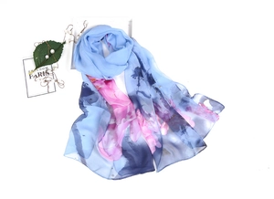 Detail of blue lotus print scarf with soft chiffon texture and artistic floral patterns
