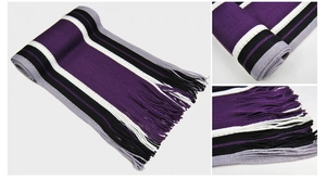 Detailed view of thick striped knit scarf with fringes in purple, black, and grey