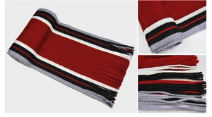 Detail of red, white and grey striped knit scarf with classic fringe edges for winter