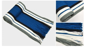 Close-up of thick knitted winter scarf with blue and grey stripes and fringe detail