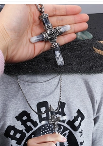 Detailed view of Gothic skull cross pendant with black marble stone on a rope chain