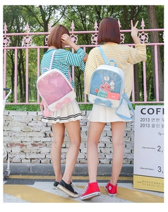 Detail of pink and blue ITA bags with clear windows for displaying plush dolls and charms