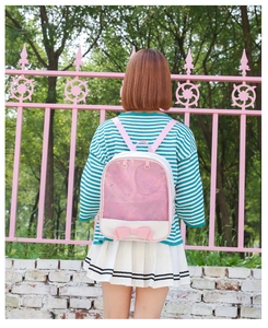 Pink heart window ita bag with glitter and bow detail worn by model outdoors