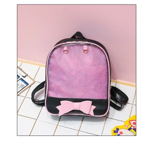 Detail of black ita bag with pink glitter window and decorative ribbon bow