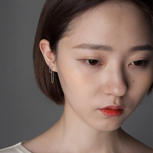 Minimalist 925 sterling silver drop earrings with metal bead and delicate tassels on model