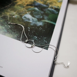 Minimalist S925 sterling silver snake chain bracelet with a central geometric ring charm