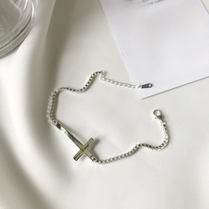 Elegant S925 sterling silver cross bracelet with 2mm box chain on white silk background