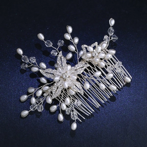 Silver bridal hair comb with elegant white pearls and sparkling rhinestone floral patterns