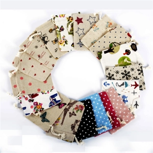 Assorted cotton linen drawstring pouches with floral and geometric patterns on white background