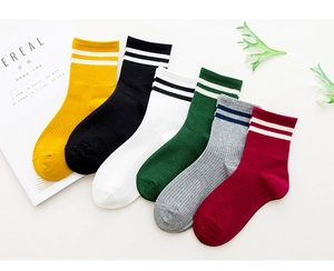 Detail view of cotton athletic crew socks in six colors with classic double stripes