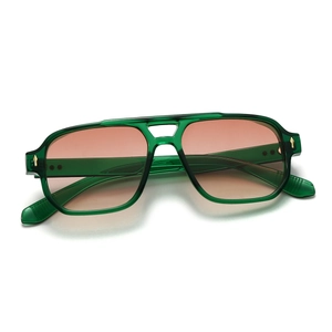 Detailed macro shot of vintage double bridge sunglasses with green frame and star rivets