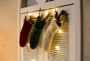 Close-up of red, green, and cream knitted Christmas stockings with cable patterns