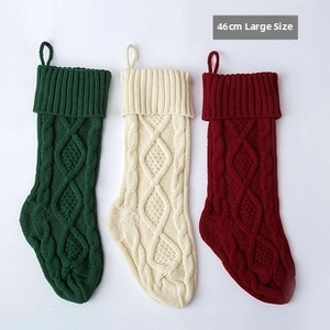 Close-up of thick cable knit texture on red, green, and white 46cm Christmas stockings
