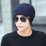 Detail of navy blue waffle knit beanie featuring a small grey decorative side woven label
