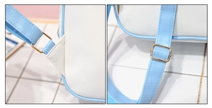 Close-up of blue shoulder strap stitching and gold metal buckles on a white bag