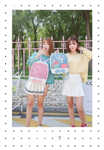 Detail of pink and blue clear PVC backpacks with cute bowknot decor and cartoon accessories
