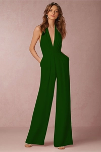 Detail of dark green halter neck jumpsuit featuring a deep V-neck and wide leg design