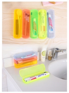 Detail of colorful translucent travel toothbrush cases arranged on a wooden background