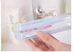 Detail showing the snap closure of the translucent blue portable toothbrush case