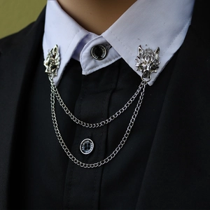 Silver wolf head lapel pin with tassel chains on black suit collar and shirt