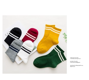 Flat lay of colorful striped cotton socks in black, red, yellow, green, and grey shades