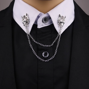Silver wolf head collar pin chain with double tassels on a black suit jacket and shirt