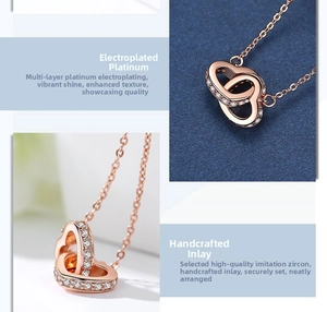 Detail of interlocking double hearts necklace in rose gold with pave cubic zirconia crystals