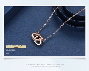 Macro shot of rose gold double heart pendant necklace with shimmering micro-pave crystals