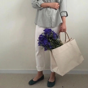 Minimalist large canvas tote bag shown in a clean lifestyle outfit styling