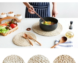 Detailed view of handwoven corn husk table mat with wooden spoon and fork cutlery set