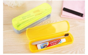 Detail showing open and closed portable toothbrush cases in yellow and green colors