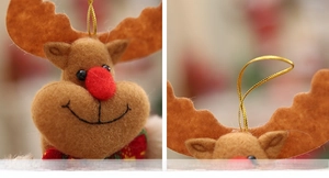 Detail of plush Christmas reindeer ornament with red nose and golden hanging string
