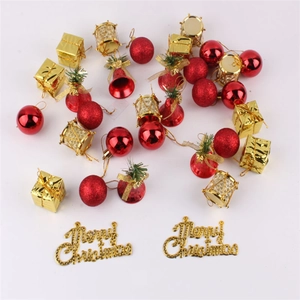 Detailed overhead view of red and gold Christmas ornaments including baubles and mini gift boxes