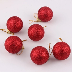 Close-up of 6 red glitter Christmas ball ornaments with gold strings on white background