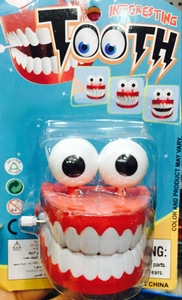 Wind-up chattering teeth prank toy with eyes in blister card packaging for Halloween