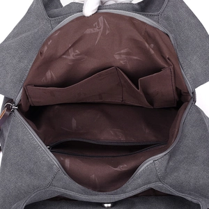 Deep gray canvas tote bag with multi-compartment interior and brown logo lining