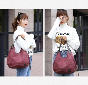 Detailed views of burgundy canvas tote bag with leather handles and spacious design