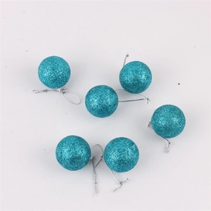 Detail of 4cm bright blue Christmas baubles with glitter texture and hanging strings