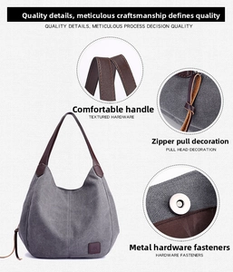 Detail view of grey canvas bag showing reinforced handles, leather puller, and magnetic snap