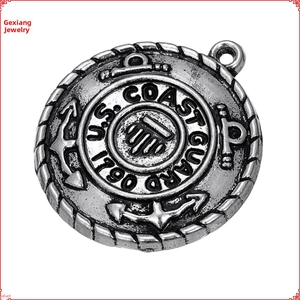 Detailed close-up of antique silver Coast Guard anchor emblem pendant with 1790 engraving