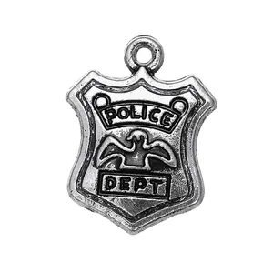 Macro shot of 14.5x19mm antique silver police badge pendant with embossed eagle logo