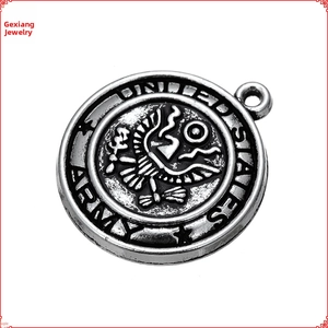 Macro detail of antique silver US Army pendant with eagle relief and star engravings